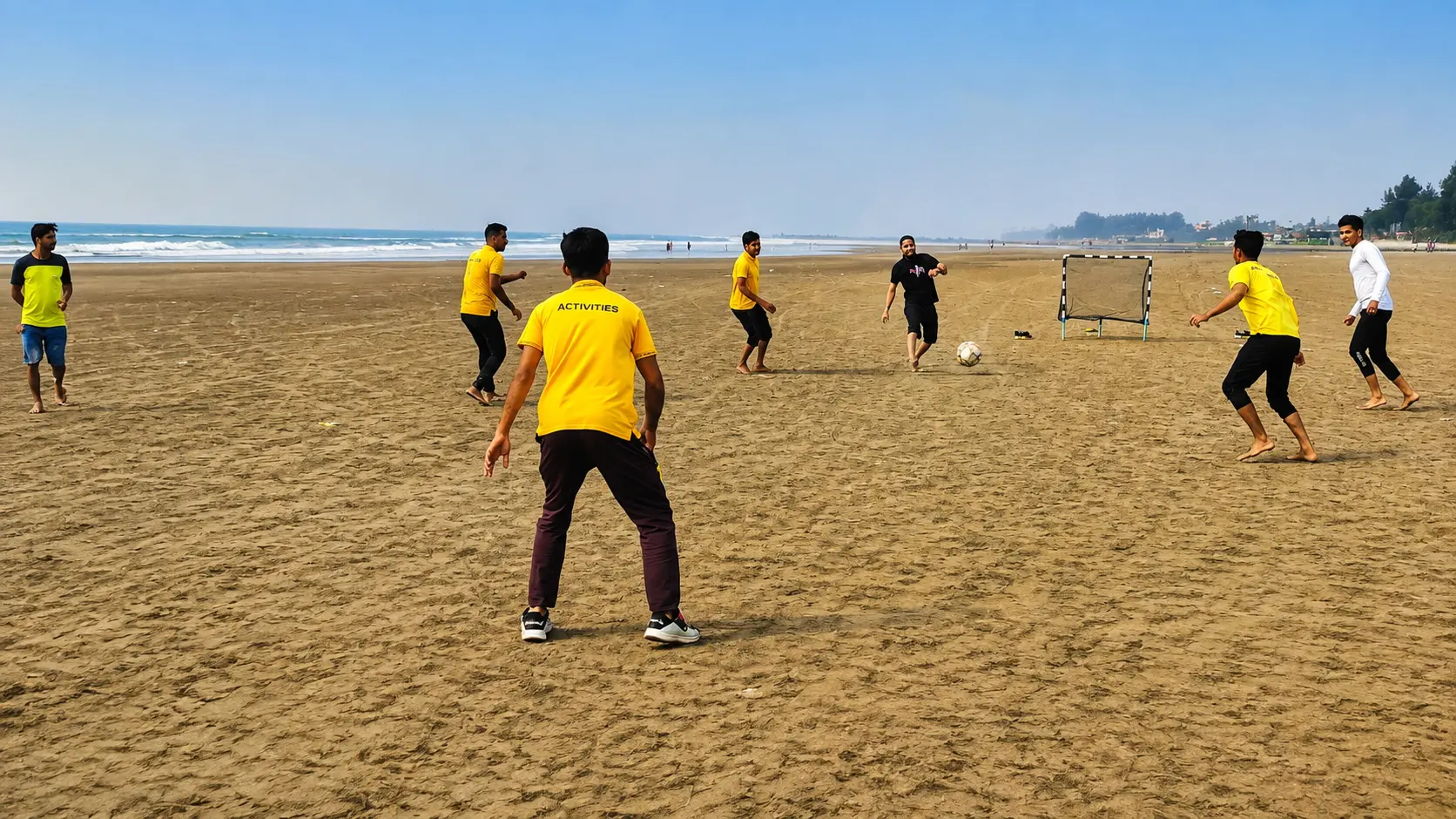 Guests playing football on the beach